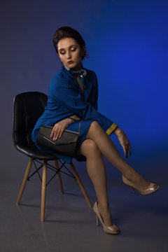 Pinup girl in suit of stewardess. Image not content logos and trademark