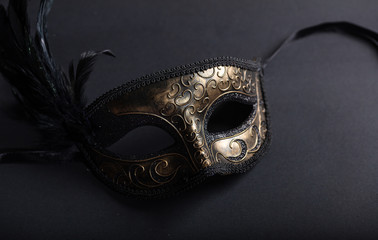 Carnival mask on black background, top view