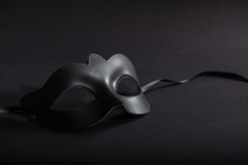Carnival mask black, on black background, copy space