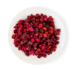 Salad venegret in a plate on a white. The view from the top.