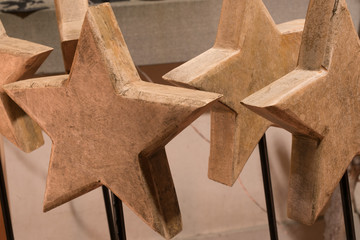 close up view of several old wooden stars used as Christmas decoration and ornaments