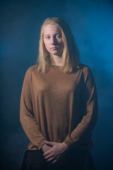 Portrait of a teenager on a dark smoky background