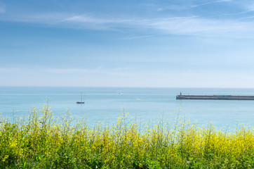 Summertime view of the Folkestone Harbour Arm in the English Channel, Kent, England