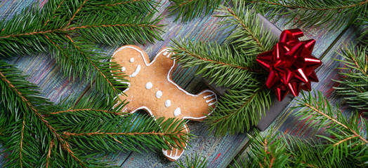 A gingerbread man with Christmas decorations and lots of fir branches.