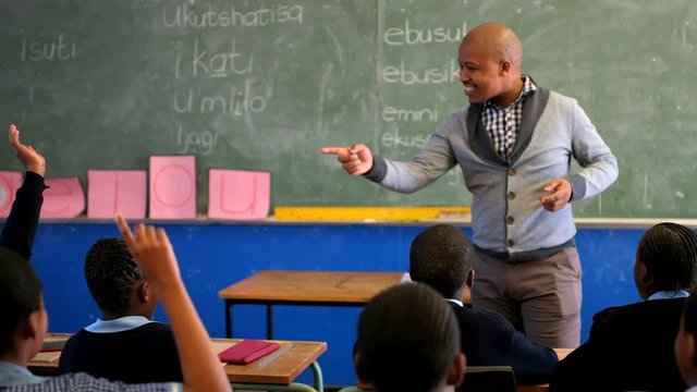 Male teacher teaching students in the classroom 4k