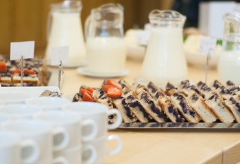 Pie pieces, drinks and cups in a catering place