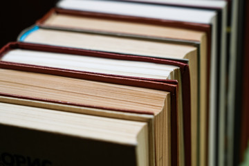Many Books Piles. Hardback books on wooden table. Back to school.