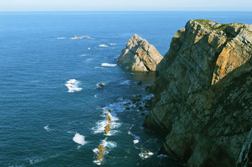 Turquoise waves of the Cantabrian Sea and palaeozoic rock formations from the Cabo de Penas in Asturias, Spain