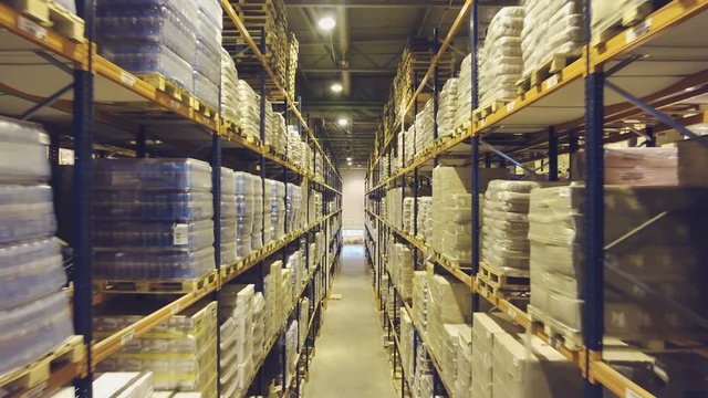 Large logistic warehouse full of goods on the racks. Warehouse full of cargo.	