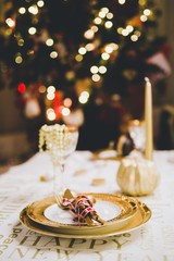 New year table setting with exclusive and luxury golden cutlery, over a tabletop with celebrations world 