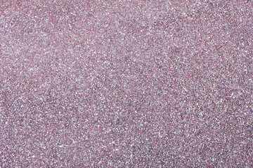 Fototapeta premium Purple asphalt pavement texture background, close up with little stones for design.