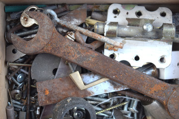 Rusty wrench is in a box with tools