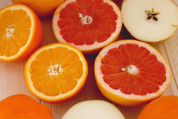 citrus fruits on wooden background close up