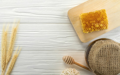 Fototapeta na wymiar Top view of Honey comb and glass honey jar on wooden background