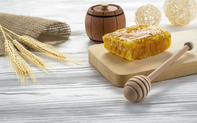 Honey comb and honey jar on wooden table