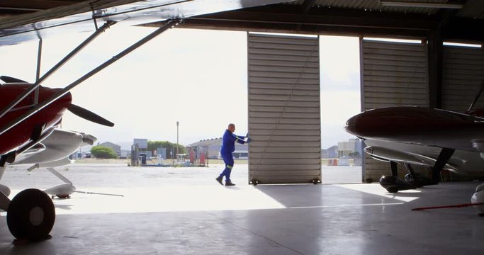 Engineer closing hangar gate 4k