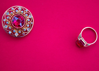 gold jewels with ruby ​​on red background