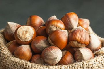 Hazelnuts, filbert in burlap sack. heap or stack of hazelnuts. Hazelnut background, healty food