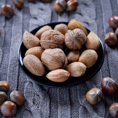 Mixed nuts in shells on the natural background: hazelnut, walnut, Brazil nut and almond.