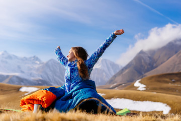 young athletic girl woke up in the morning, in the background of an inspiring landscape, the...