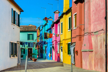 Fototapeta na wymiar Colorful houses near canal on Burano island, Venice, Italy.