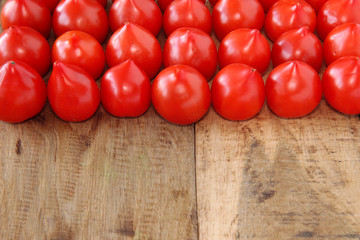 fresh tomatoes on wooden board