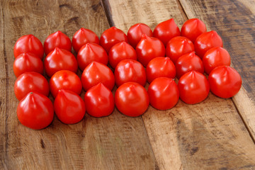 fresh tomatoes on wooden table