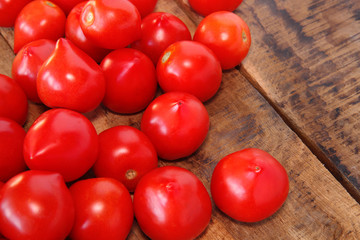 fresh tomatoes on wooden table