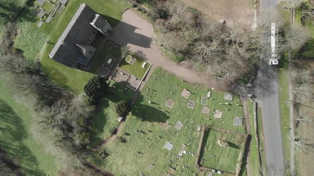 A bird's eye view of an old irish chapel and a graveyard