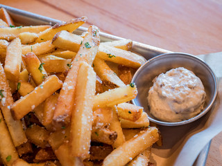 Close up shot of french fries with sauce