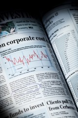 Open Newspaper with Article about Finances - Close Up