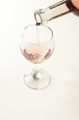 Transparent glass of wine. Pink wine. Festive mood. Alcohol for a group of friends. Delicious drink. Light background. Noble drink. Lavender and rose wine. Wine from lavender