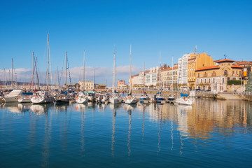 Fototapeta na wymiar Gijon cityscape. Yatchs in marina port of Gijon, Asturias, Spain.