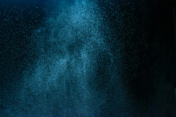 Water jet spraying on black background