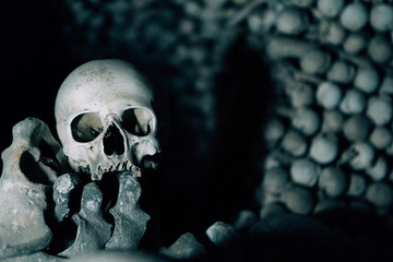 The Human skull and bones are in the dark catacomb night shoot