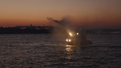 Fireboat spraying water on the Bosporus strai in Istanbul, Turkey.