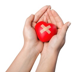 Hands Holding a Heart with Adhesive Bandage
