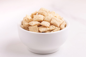 Corn pads in clay bowl on light white background