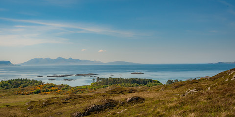 View of Isle of Skye and Inner Hebridean Islands across sea from coast
