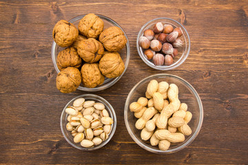 Dried fruits on bowls on a wooden table top view