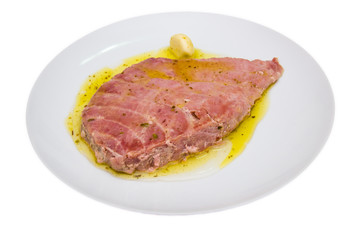 Slice of tuna on plate on a white background