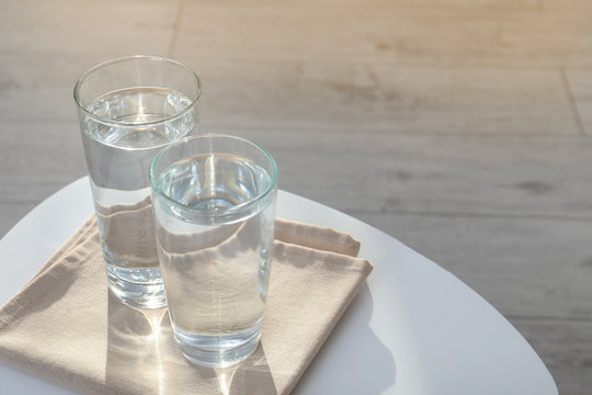 Glasses with pure water on table indoors. Space for text