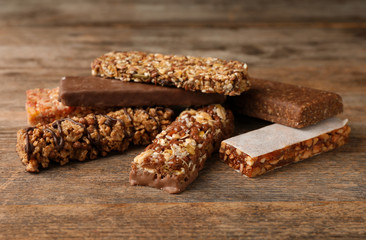 Tasty protein bars on wooden table. Healthy snack