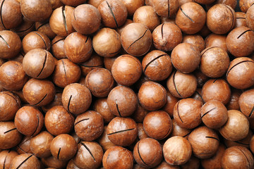 Organic Macadamia nuts as background, top view