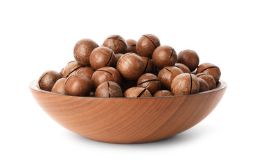 Bowl with organic Macadamia nuts on white background