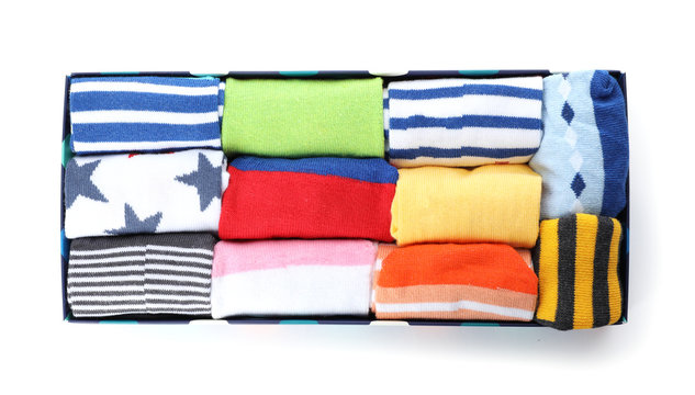 Box of child socks on white background, top view