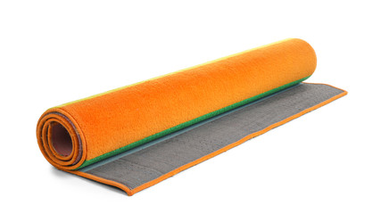 Rolled colorful carpet on white background. Interior element