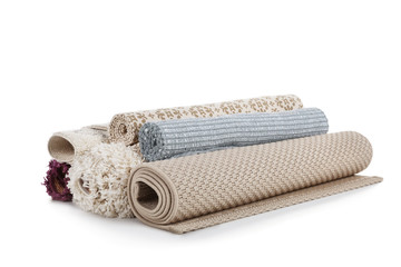 Different rolled carpets on white background. Interior element