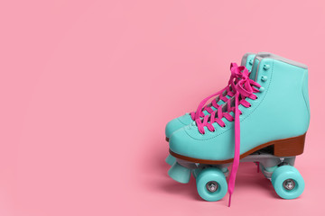 Pair of stylish quad roller skates on color background. Space for text © New Africa