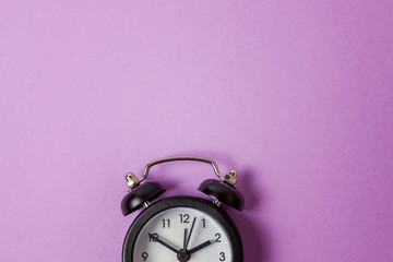 Ringing twin bell vintage classic alarm clock Isolated on purple violet pastel colourful background. Rest hours time of life good morning night wake up awake concept. Flat lay top view copy space